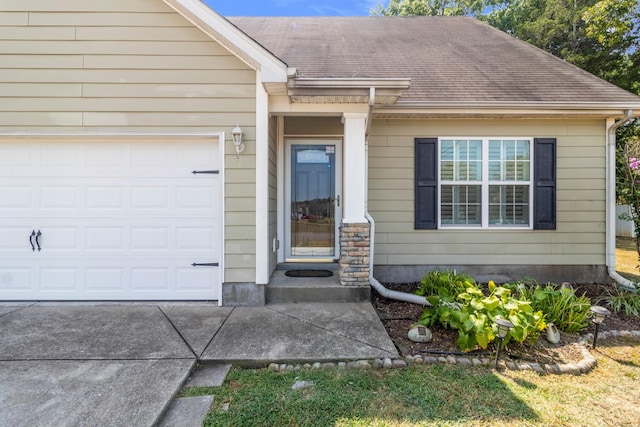 property entrance featuring a shingled roof and an attached garage