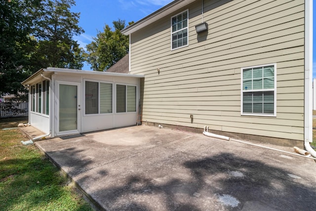 back of property featuring a sunroom and a patio