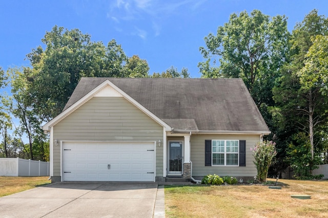 view of front of property featuring an attached garage, a shingled roof, fence, driveway, and a front yard