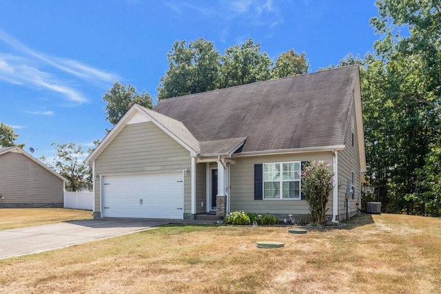 view of front of house featuring a garage, a front yard, concrete driveway, and central AC unit