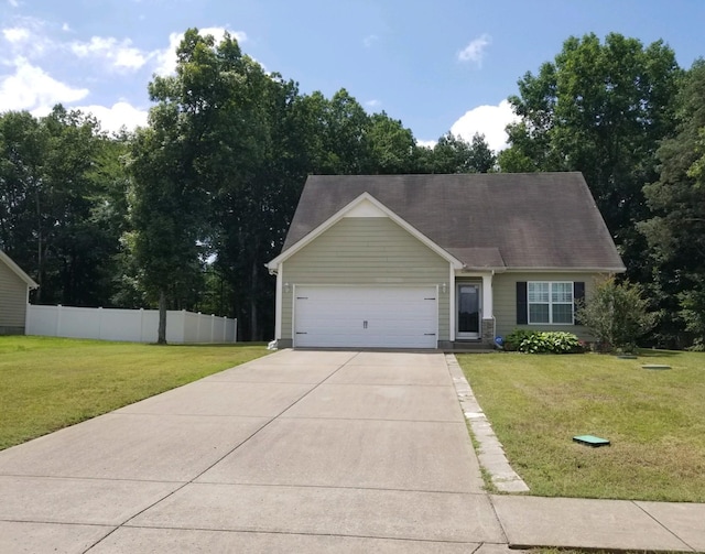 view of front facade with an attached garage, fence, concrete driveway, and a front yard