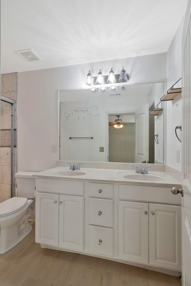 bathroom with double vanity, visible vents, and a sink