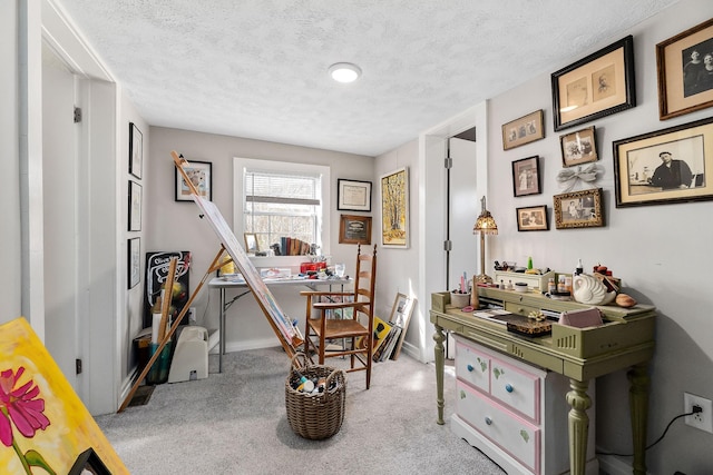 rec room with a textured ceiling, carpet, and baseboards