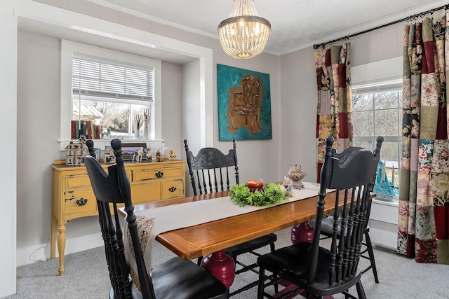 dining room with ornamental molding, a chandelier, a wealth of natural light, and light colored carpet