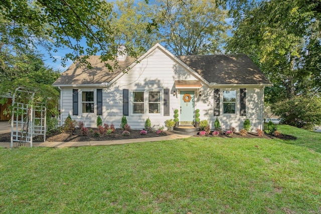 view of front of property with a shingled roof and a front lawn