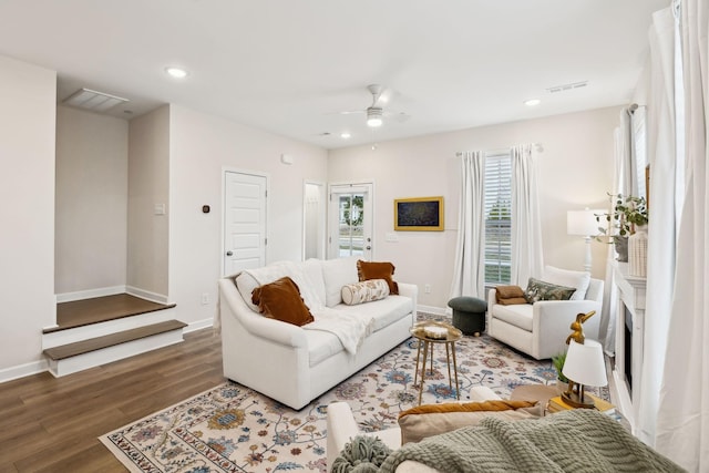 living area with a ceiling fan, recessed lighting, baseboards, and wood finished floors