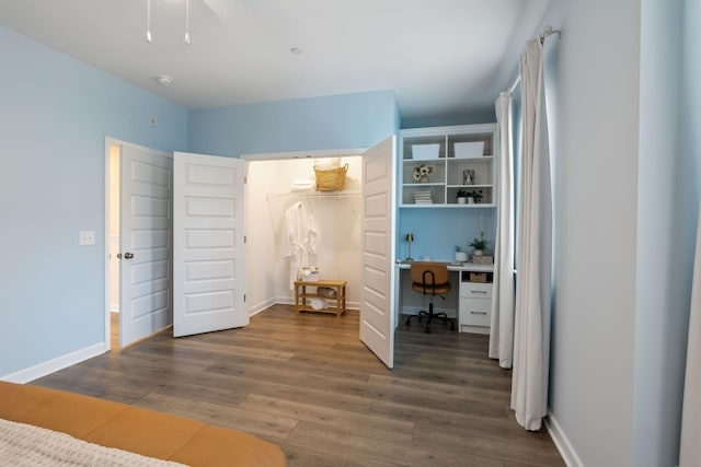 bedroom featuring a closet, baseboards, and wood finished floors