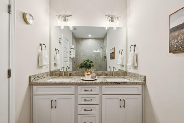 bathroom with double vanity, a sink, and a shower stall