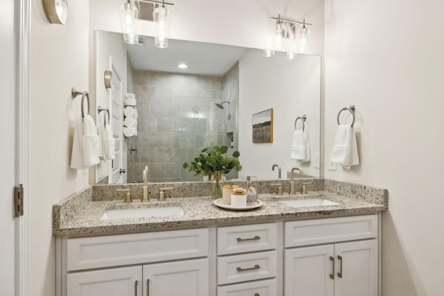 full bathroom featuring a stall shower, a sink, and double vanity