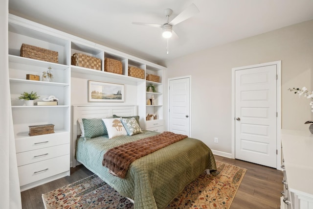 bedroom with a ceiling fan and dark wood-style flooring