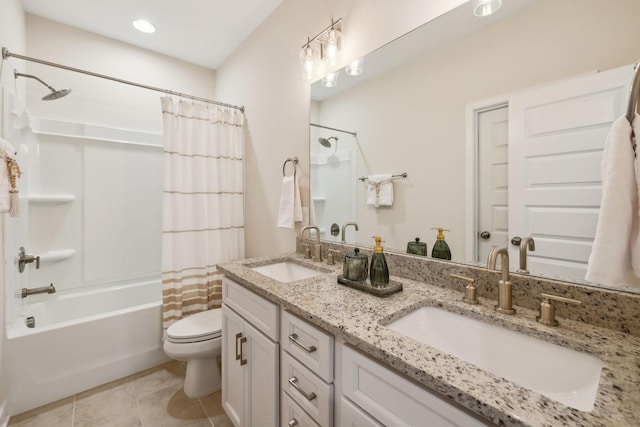 full bathroom featuring toilet, tile patterned flooring, shower / bath combo with shower curtain, and a sink