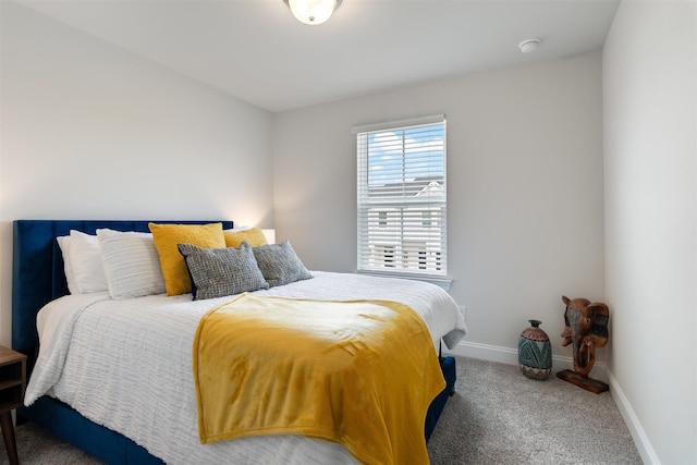 carpeted bedroom featuring baseboards