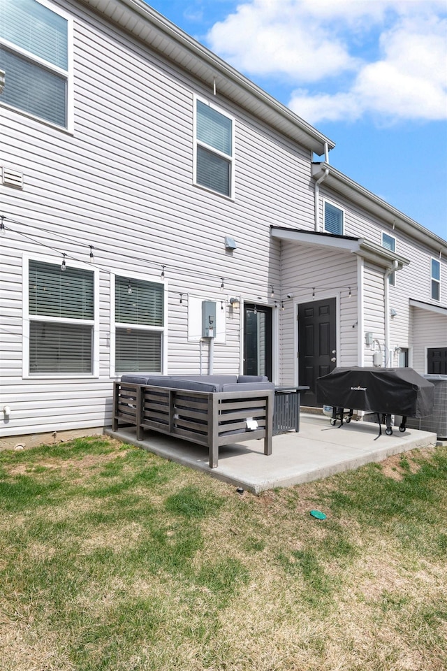 rear view of house with a patio area and a lawn