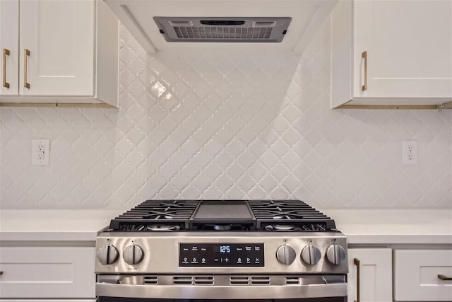 kitchen featuring stainless steel gas stove, white cabinets, and light countertops