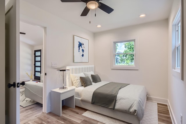 bedroom featuring baseboards, ceiling fan, light wood-type flooring, and recessed lighting