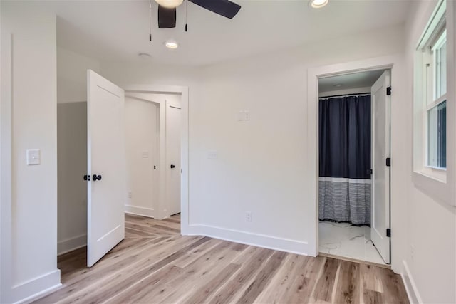 unfurnished bedroom with light wood-type flooring, baseboards, and recessed lighting