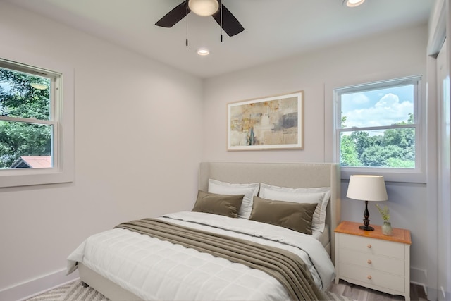 bedroom featuring ceiling fan, multiple windows, baseboards, and recessed lighting