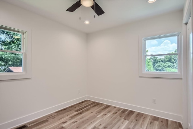 spare room featuring light wood-style flooring, baseboards, a ceiling fan, and recessed lighting