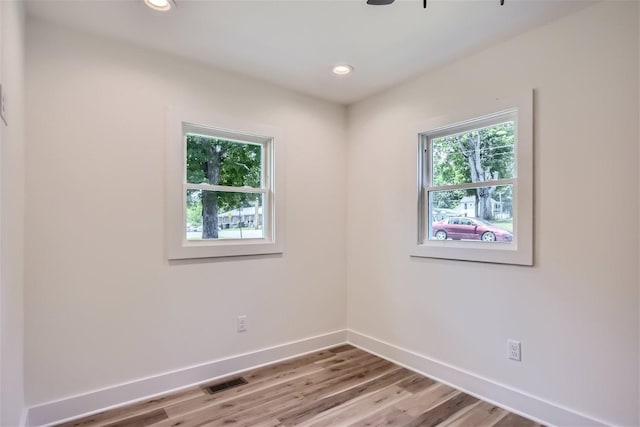 spare room featuring recessed lighting, light wood-type flooring, visible vents, and baseboards