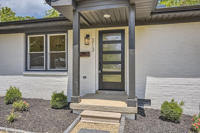 entrance to property with brick siding