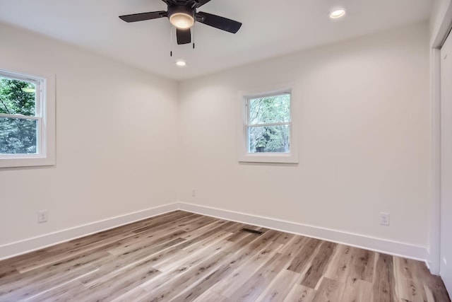 unfurnished room with light wood-type flooring, baseboards, a ceiling fan, and recessed lighting