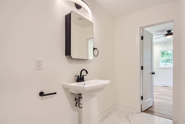 bathroom with marble finish floor and baseboards