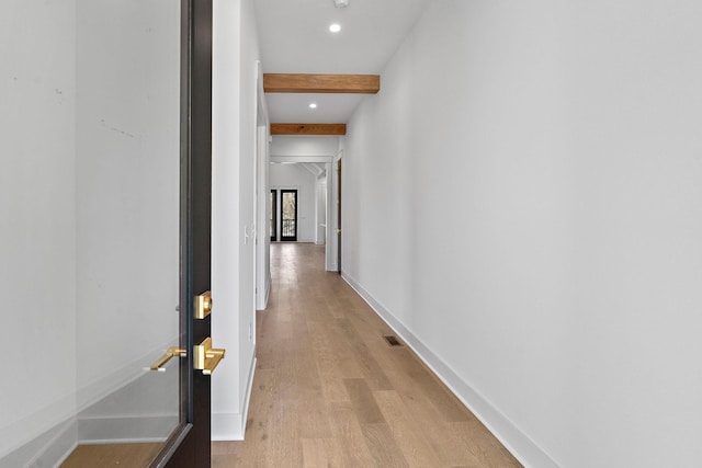 corridor with light wood-style flooring, recessed lighting, visible vents, baseboards, and beamed ceiling