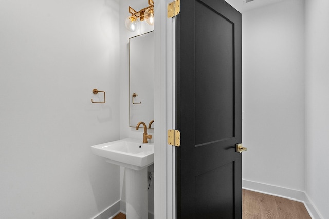 bathroom featuring baseboards and wood finished floors