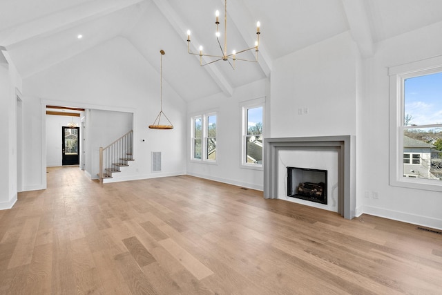 unfurnished living room featuring a healthy amount of sunlight, a premium fireplace, and visible vents