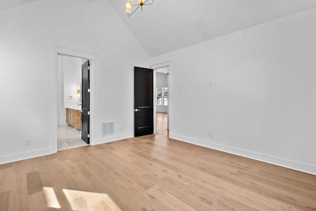 unfurnished bedroom featuring light wood finished floors, visible vents, an inviting chandelier, high vaulted ceiling, and baseboards