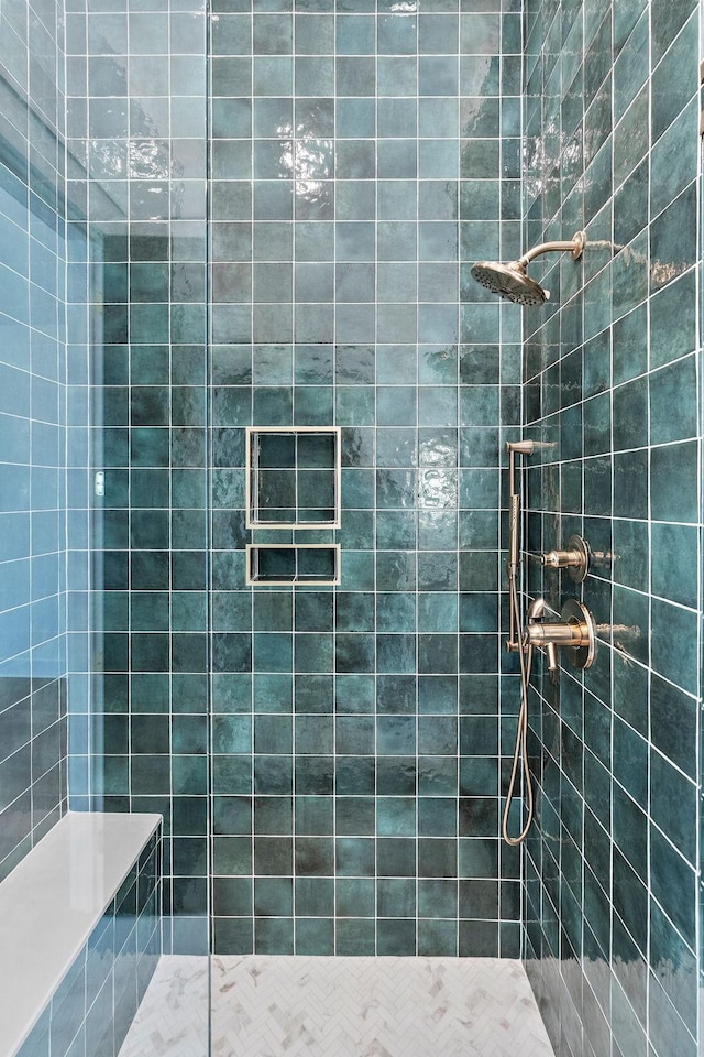 bathroom with a tile shower