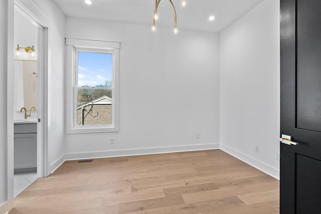 unfurnished room featuring light wood-type flooring, baseboards, and recessed lighting