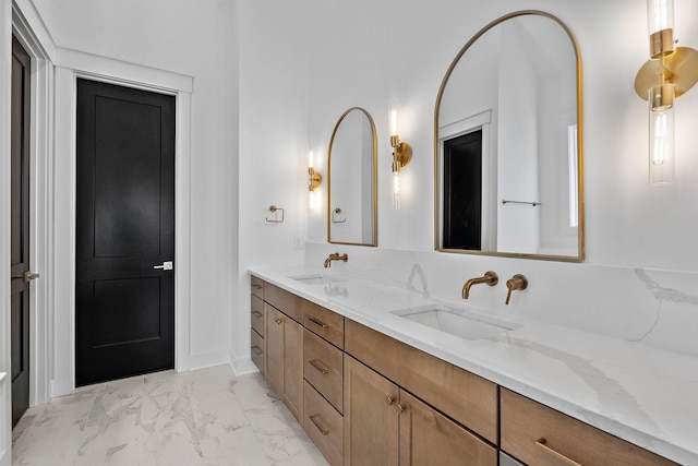 full bathroom featuring double vanity, marble finish floor, and a sink