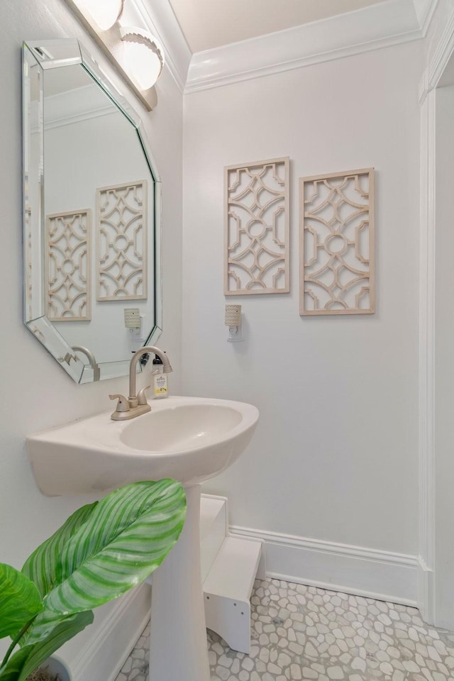 bathroom featuring baseboards and crown molding