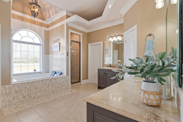 full bathroom featuring a garden tub, tile patterned flooring, crown molding, vanity, and a shower stall