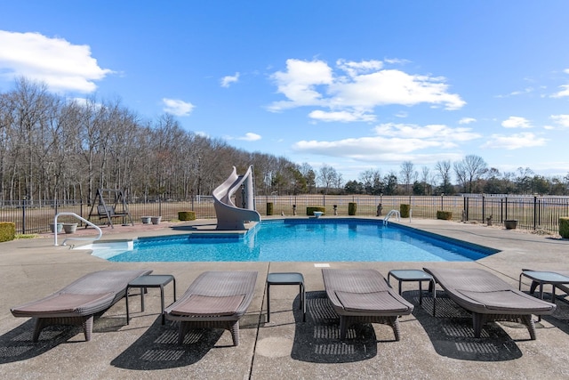 view of pool featuring a water slide, a patio area, and fence