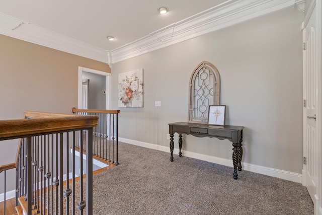 hallway featuring carpet floors, baseboards, ornamental molding, and an upstairs landing