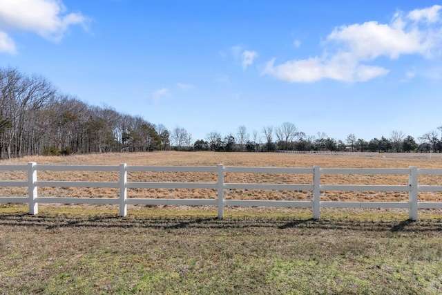 view of yard featuring fence and a rural view