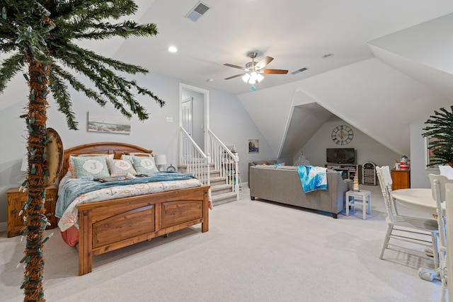 bedroom featuring light colored carpet, lofted ceiling, and visible vents