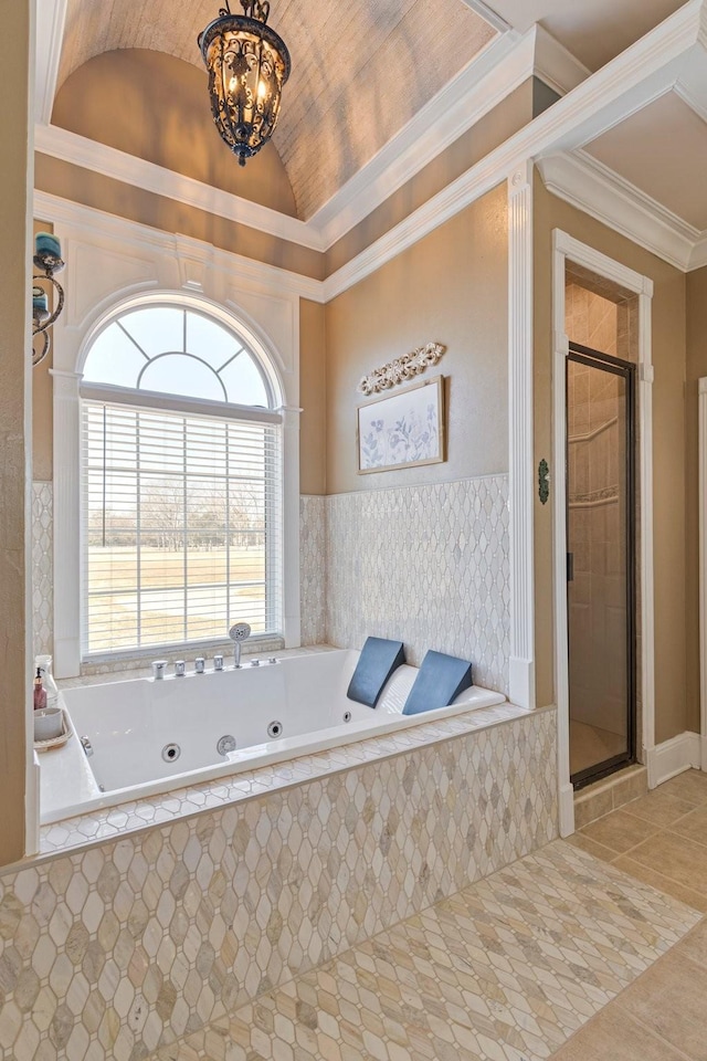 full bathroom with ornamental molding, tile patterned floors, a jetted tub, vaulted ceiling, and a shower stall