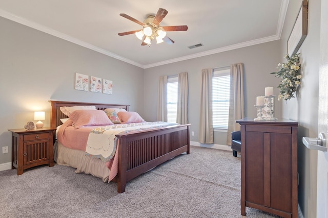 bedroom featuring light colored carpet, crown molding, visible vents, and baseboards