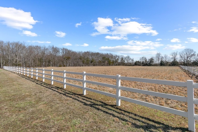 view of yard featuring a rural view and fence