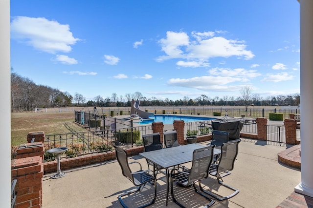 view of patio / terrace featuring a fenced in pool and fence