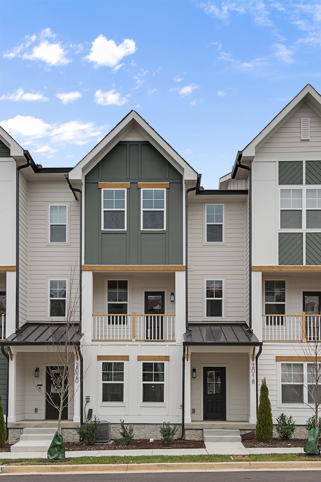 townhome / multi-family property with metal roof, a standing seam roof, and board and batten siding