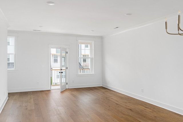 unfurnished room with wood-type flooring and baseboards