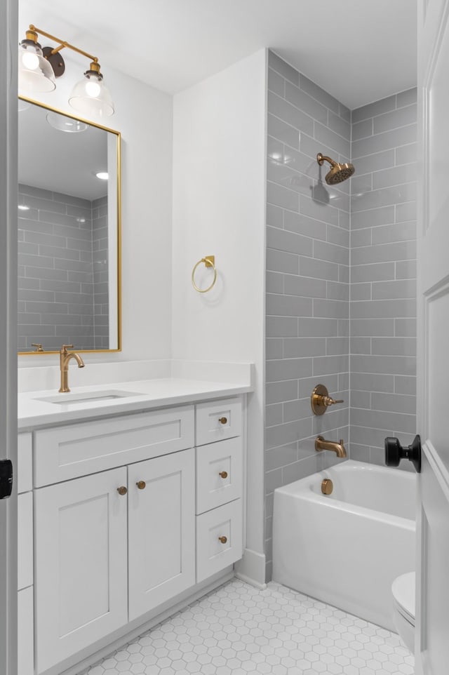 bathroom with  shower combination, tile patterned floors, toilet, and vanity