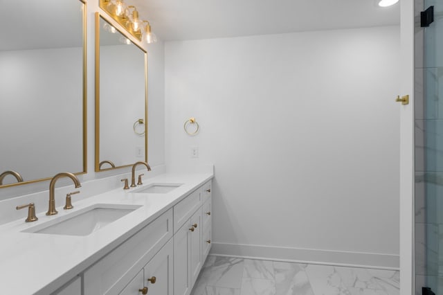 bathroom featuring marble finish floor, a sink, baseboards, and double vanity