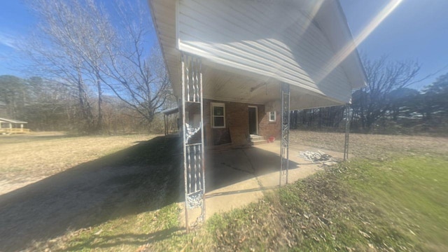 view of side of home featuring brick siding and a yard