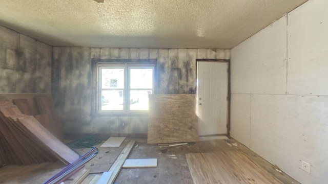 unfurnished room featuring a textured ceiling