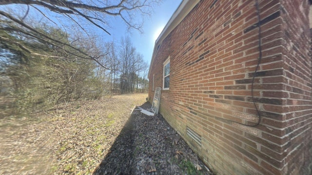 view of side of property with brick siding